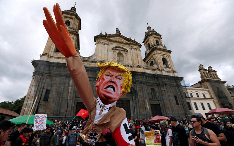Protesters carry a cut-out depicting U.S. President Donald Trump, wearing a Nazi uniform, during a rally commemorating May Day in Bogota, Colombia on 1 May, 2018. Photo: REUTERS