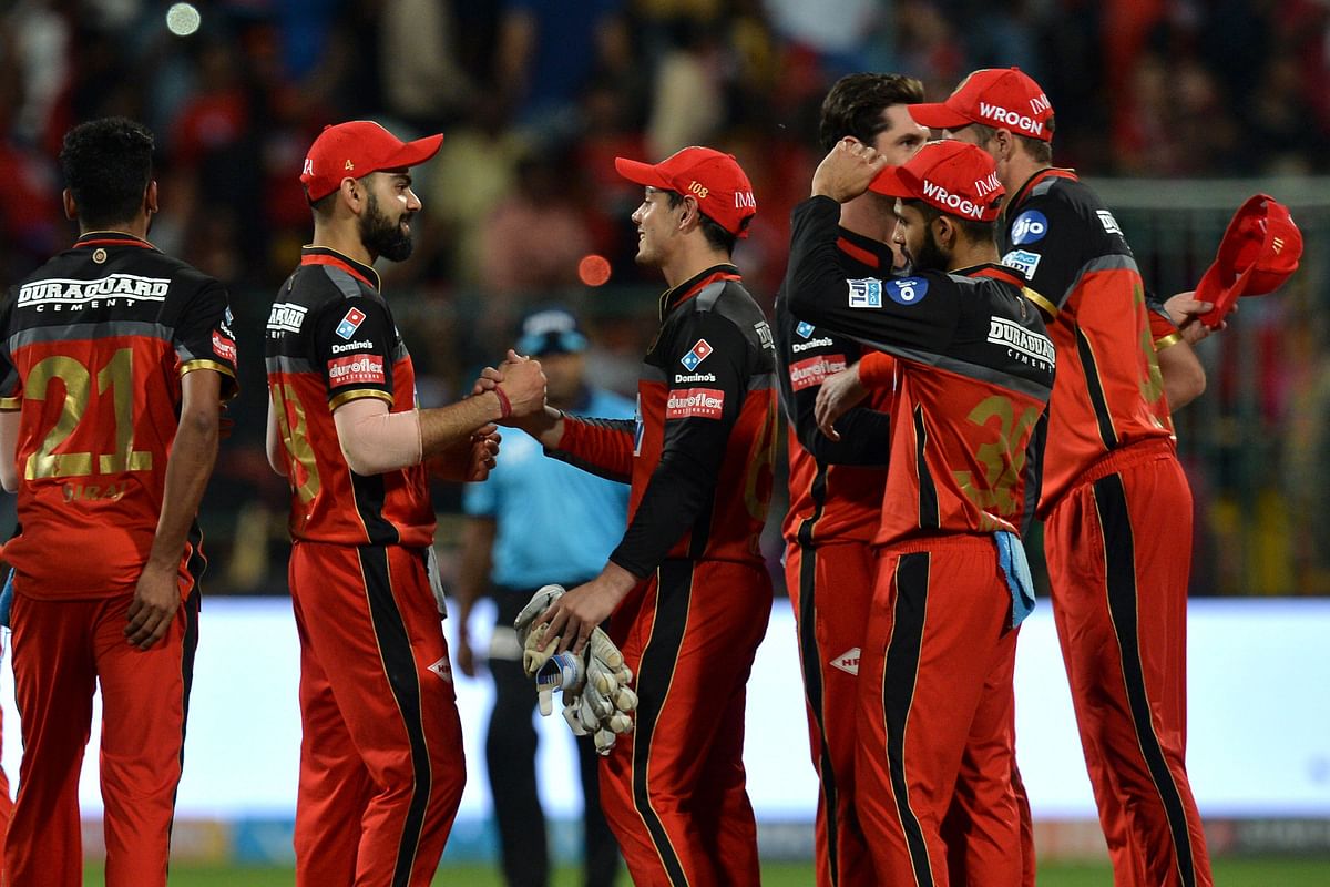 Royal Challengers Bangalore captain Virat Kohli (2ndL) greet his teammates after his team won the match by 15 runs during the 2018 Indian Premier League (IPL) Twenty20 cricket match against Mumbai Indians at The M. Chinnaswamy Stadium in Bangalore on 1 May 2018. AFP