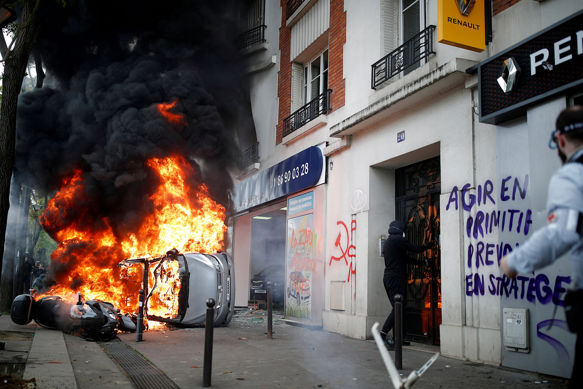 A car burns outside a Renault automobile garage during clashes at the May Day labour union march in Paris, France on 1 May. Photo: Reuters