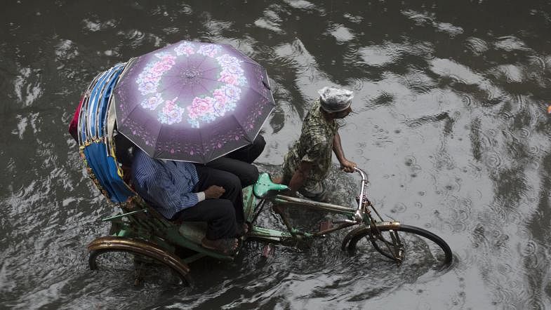 Sewerage and rainwater clog the road of Bashpotti, Shanir Akhra, Dhaka on 2 May. Photo: Hasan Raja.