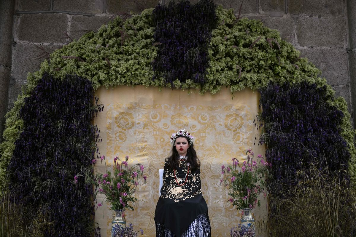 Marah Corrales Alfonso takes part in the `Las Mayas` festival in Colmenar Viejo near Madrid, Spain on 2 May 2018. The Mayas, young girls aged between 7 and 11, are required to sit still in a decorated altar derived from pagan rites celebrating the arrival of spring. Photo: AFP