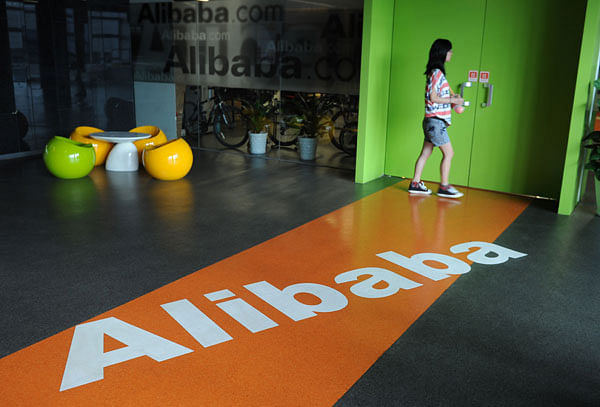 In this file photo taken on 20 June, 2012 an Alibaba employee walks through a communal space at the company`s headquarters in Hangzhou. Chinese e-commerce giant on 4 May, 2018 announced a massive 47 per cent leap in net profit for the fiscal year 2017/2018. Photo: AFP