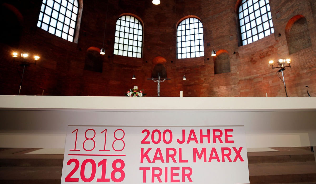 A sign dedicated to Karl Marx 200th anniversary celebrations is seen at the Basilica of Constantine in Trier, Germany on 4 May 2018. Reuters