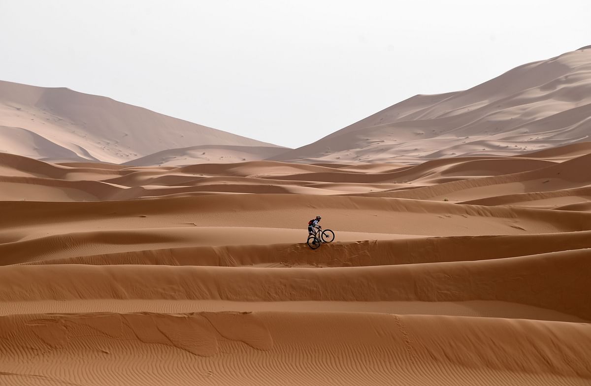 A competitor rides his bike along a sand dune during Stage 5 of the 13th edition of Titan Desert 2018 mountain biking race around Merzouga in Morocco on 3 May 2018. The Titan Desert 2018 is 600 kilometre mountain bike race completed over six days, snaking between Boumalne Dades, at the foot-slopes of the High Atlas summits, and Erfoud, an oasis town in the Sahara Desert. AFP