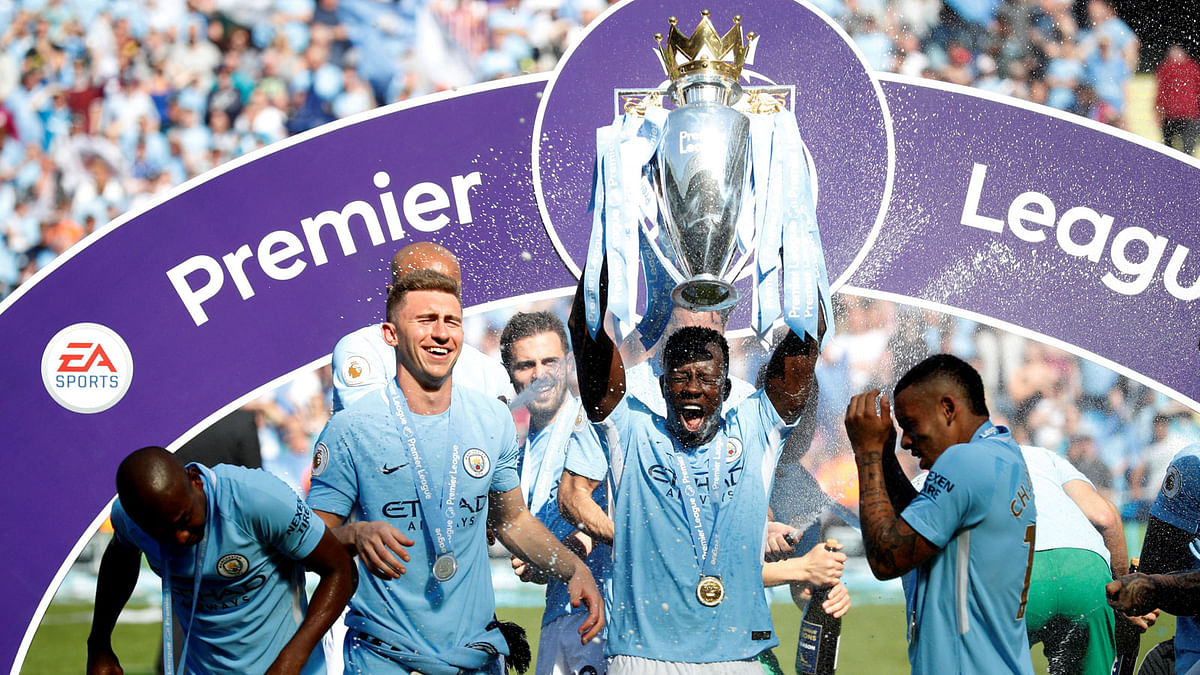 Manchester City`s Benjamin Mendy celebrates with the trophy after winning the Premier League title. Reuters
