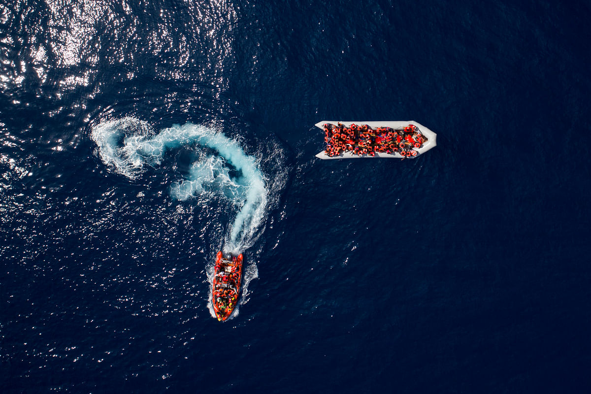 Refugees and migrants are rescued by members of the Spanish NGO Proactiva Open Arms, after leaving Libya trying to reach European soil aboard an overcrowded rubber boat, north of Libyan coast on 6 May. Photo: AP