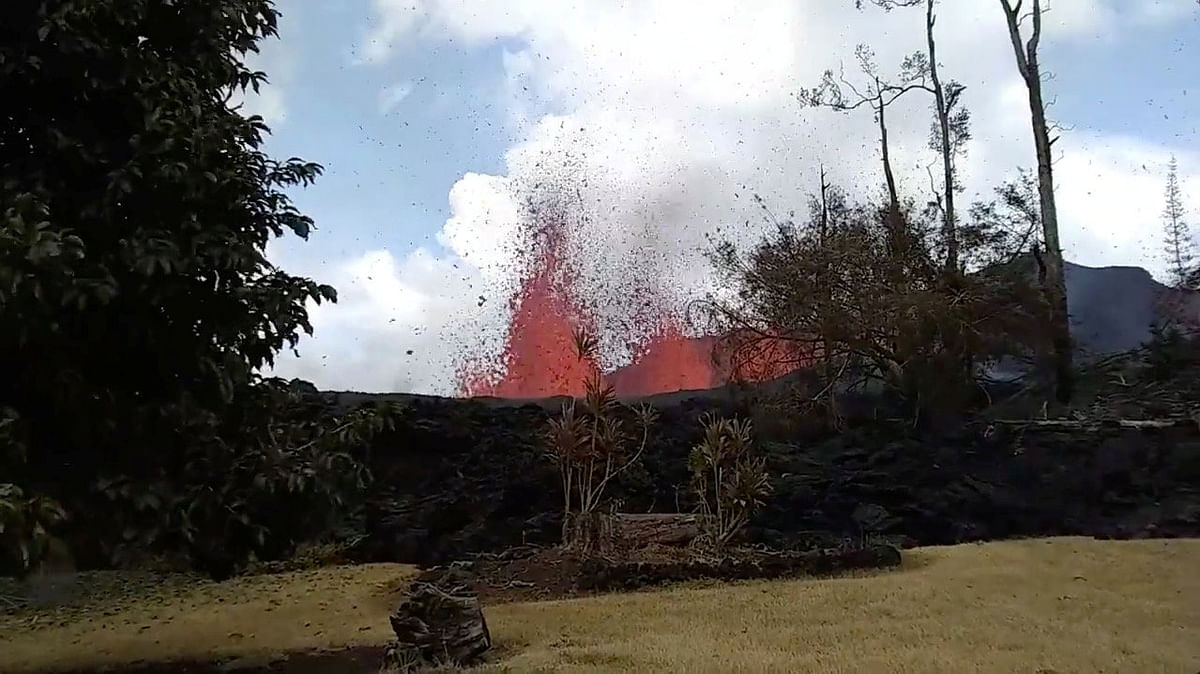 Lava is seen from a fissure appearing behind a resident`s backyard in Puna, Hawaii, US in this still frame taken from 6 May 2018 video obtained from social media. Reuters