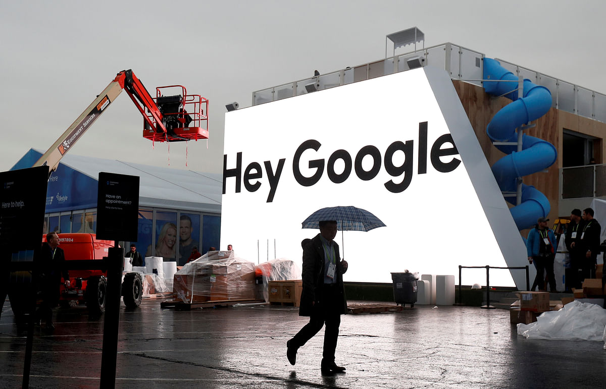 A man walks through light rain in front of the Hey Google booth under construction at the Las Vegas Convention Center in preparation for the 2018 CES in Las Vegas, Nevada, US on 8 January 2018. Photo: Reuters