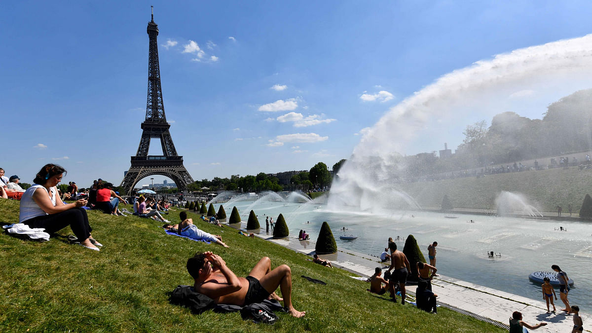 People sunbathe next the fountain at the Trocadero Esplanade, near the Eiffel Tower on 8 May. Photo: AFP