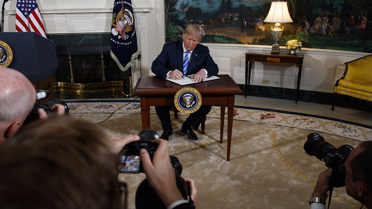 US president Donald Trump signs a Presidential Memorandum on the Iran nuclear deal from the Diplomatic Reception Room of the White House, on 8 May 2018, in Washington. Photo: AP