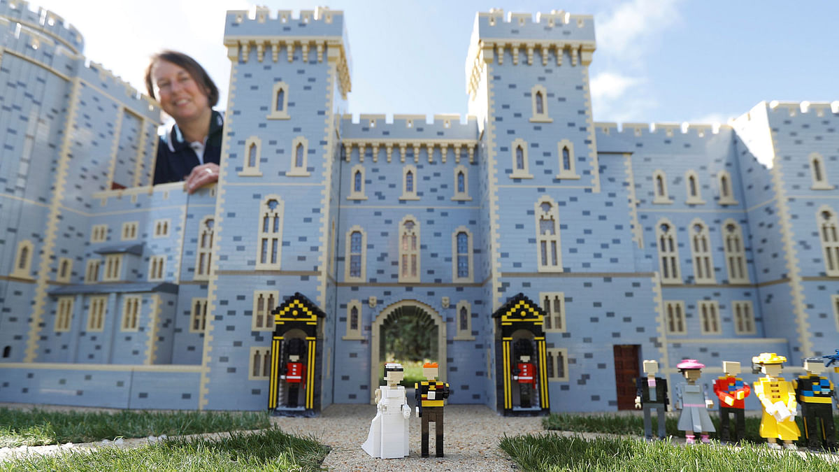 Head model maker, Paula Laughton poses for a photograph with a LEGO Windsor Castle replete with royal wedding between Britain’s prince Harry and Meghan Markle, in Windsor, Britain on 10 May. Photo: Reuters