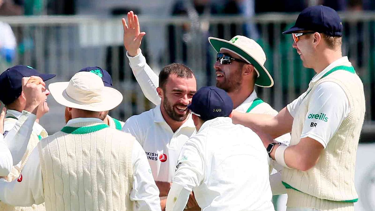 Ireland`s Stuart Thompson (C) celebrates with team-mates after taking the wicket of Pakistan`s Haris Sohail during play on day two of Ireland`s inaugural test match against Pakistan at Malahide cricket club, in Dublin on 12 May, 2018. Photo: AFP