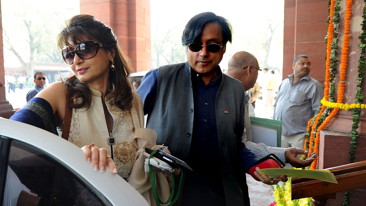 In this photograph taken on 12 March 2012, ex-junior minister for external affairs and Congress Party`s Member of Parliament Shashi Tharoor (R) with his wife Sunanda Pushkar arrive at parliament for the opening of the budget session in New Delhi. Delhi police on 14 May charged a former high-flying UN diplomat and a popular opposition figure with abetting his wife`s suicide four years ago in a case that riveted the country. AFP