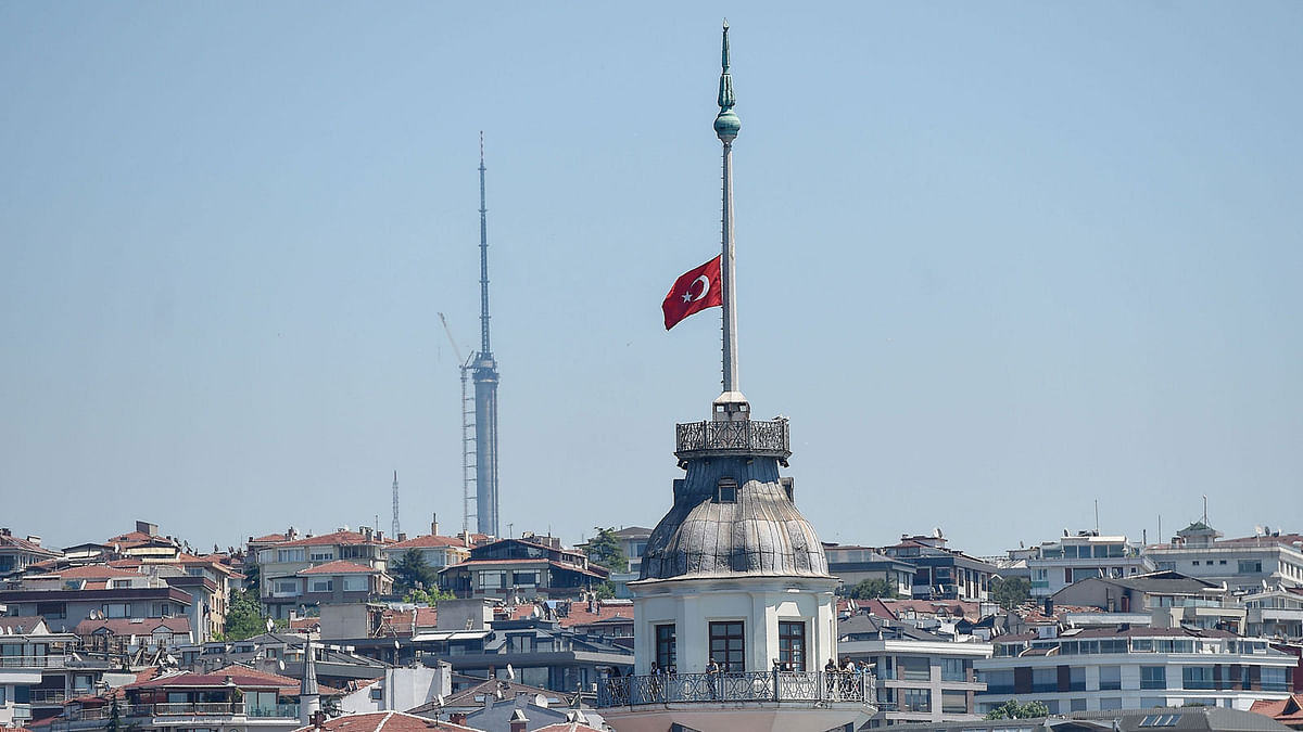 A Turkish flag flies at half-mast from the Maiden Tower in Istanbul on 15 May, 2018. Photo: AFP