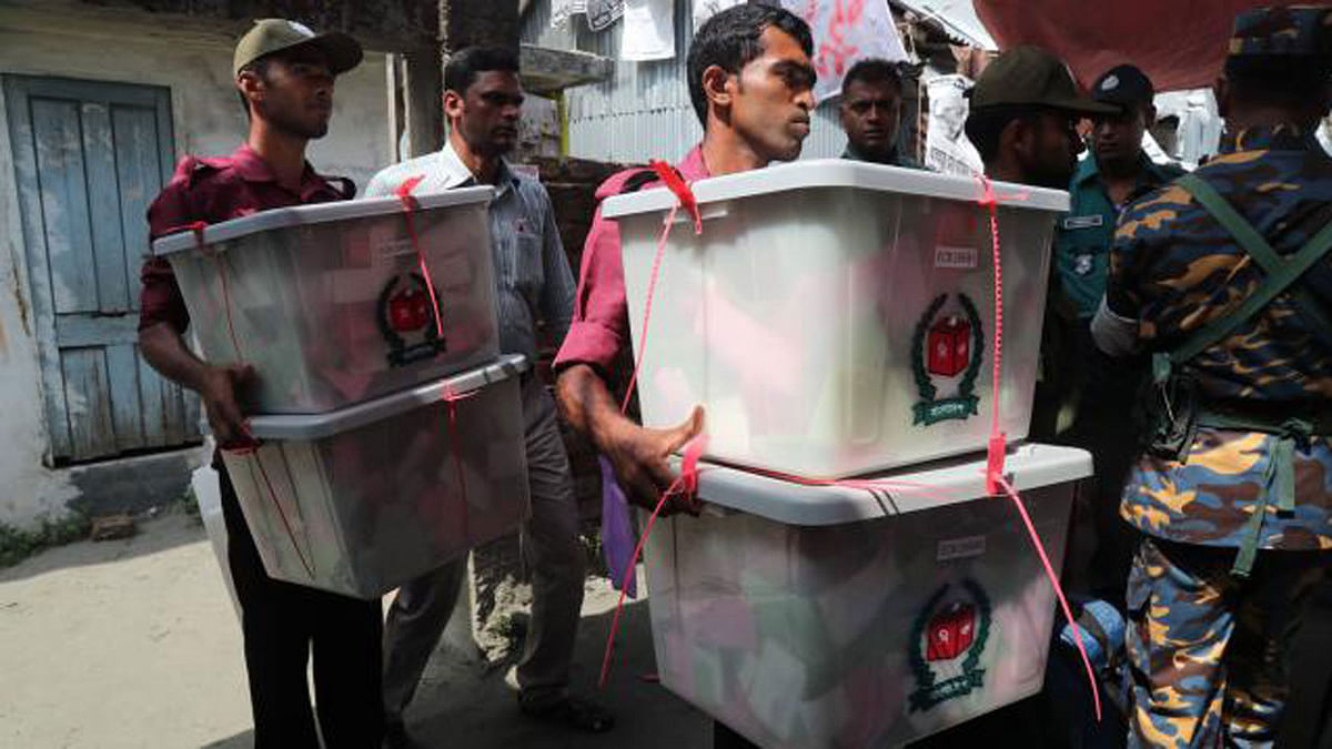 At one stage of casting vote, ballot boxes full of ballot papers are being taken away from a polling station at Labonchara Government Primary School in Khulna on 15 May. Photo: Sajid Hossain