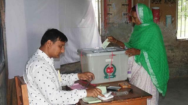 A voter casts her vote at KDA Khan Jahan Ali Government School centre in a Fulbari Gate area, Khulna, on 15 May. Photo: Saddam Hossain