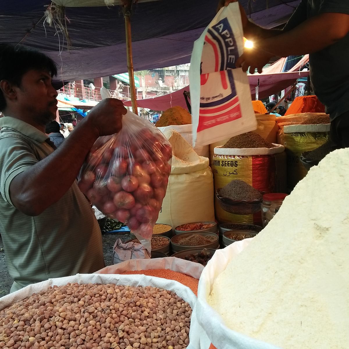 Abdur Rahim, 40, was buying ground spices from Karwan Bazar and was carrying a heavy bag of onions. Photo: Nusrat Nowrin
