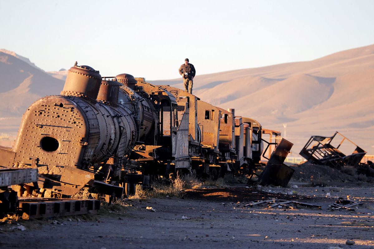A man stands on an old train of Bolivian Railways Company from 1870-1900 at the train cemetery in Uyuni, Potosi, Bolivia, 11 May 2018. Photo: Reuters