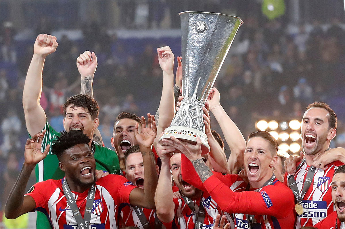 Atletico Madrid players Gabi and Fernando Torres lift the trophy as they celebrate winning the Europa League beating Olympique de Marseille at Groupama Stadium, Lyon, France on 16 May 2018. Reuters
