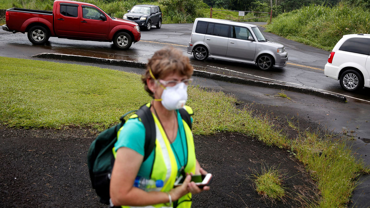 A geologist inspects cracks on a road in Leilani Estates, following eruption of Kilauea volcano, Hawaii on 17 May. Photo: Reuters