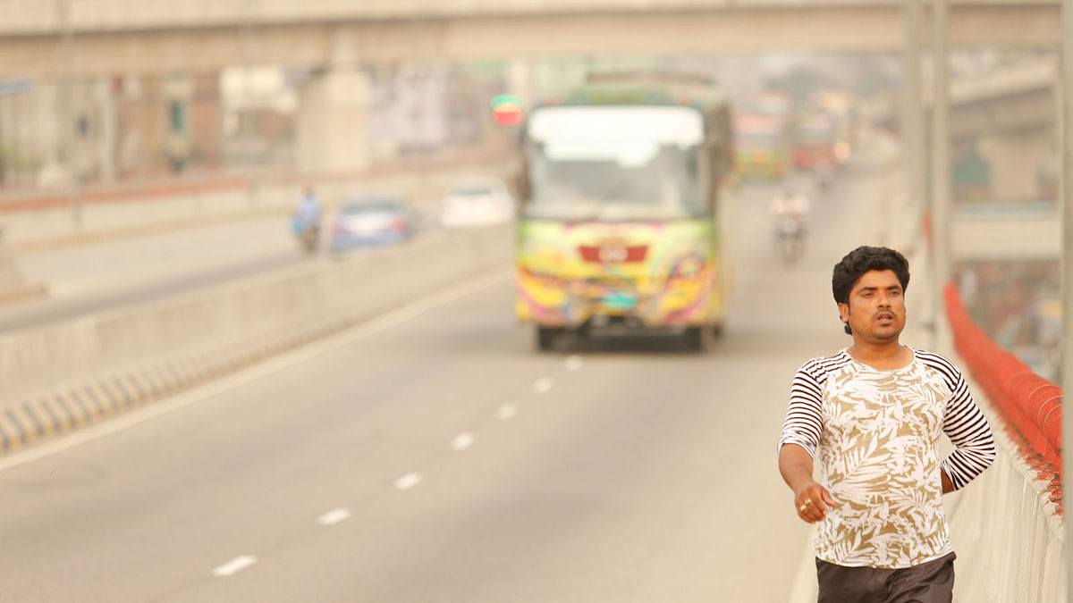 A man walks on the mayor Hanif flyover in Dhaka although it is forbidden to do so. Sumon Yusuf took this photo on 17 May.