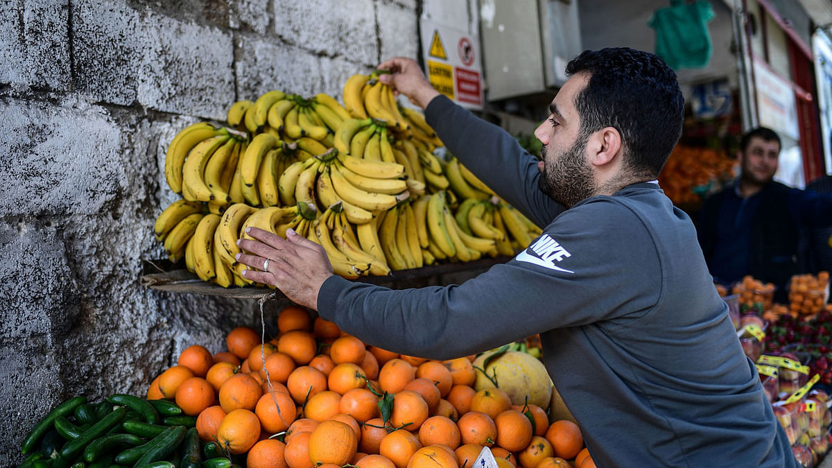 A Syrian greengrocer displays bananas on a stall of his shop, in Gaziantep in the south-west province of Turkey on 1 May. Photo: AFP