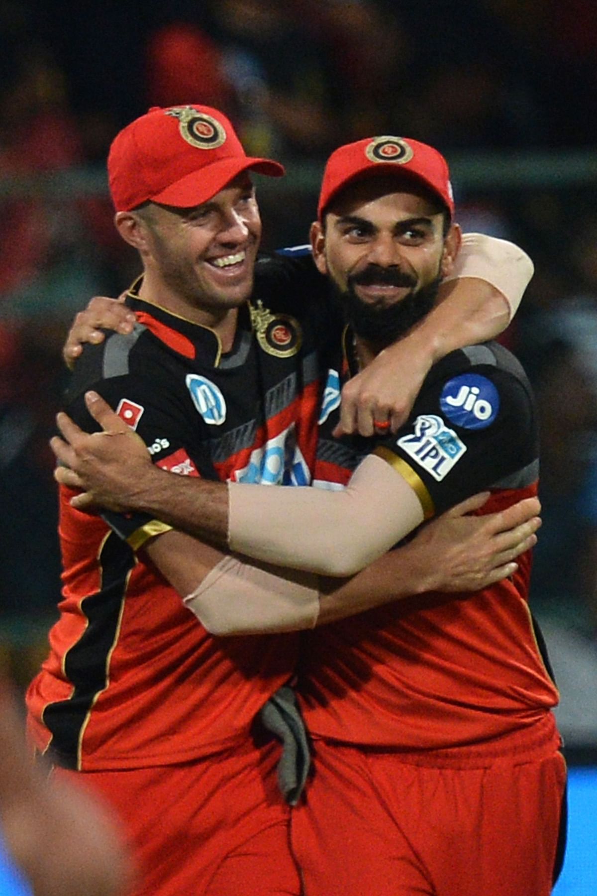 In this file photo taken on 17 May, 2018 Royal Challengers Bangalore captain Virat Kohli (R) and AB De Villiers celebrate the team`s 14 run victory during the 2018 Indian Premier League (IPL) Twenty20 cricket match between Royal Challengers Bangalore and Sunrisers Hyderabad at The M Chinnaswamy Stadium in Bangalore. Photo: AFP