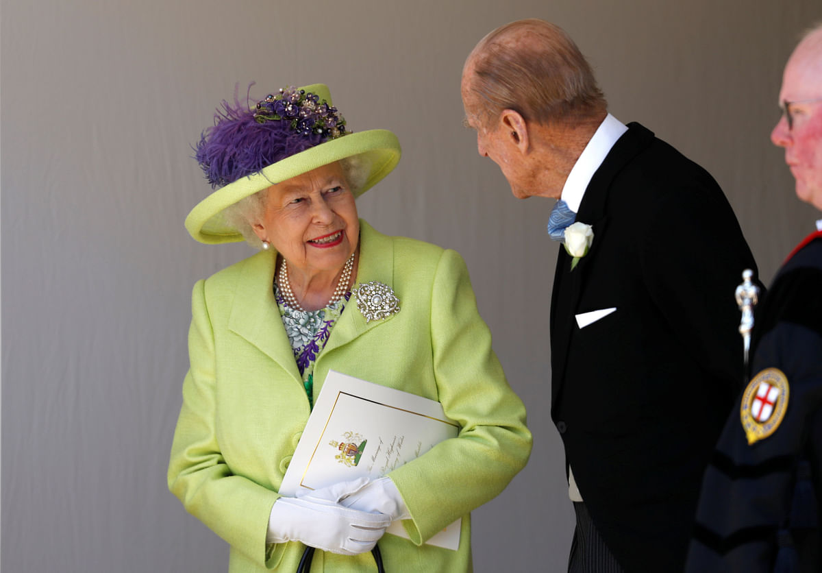 Britain`s Queen Elizabeth talks with Prince Philip after the wedding ceremony of Prince Harry and Meghan Markle at St. George`s Chapel in Windsor Castle in Windsor, Britain, 19 May, 2018. Photo: Reuters