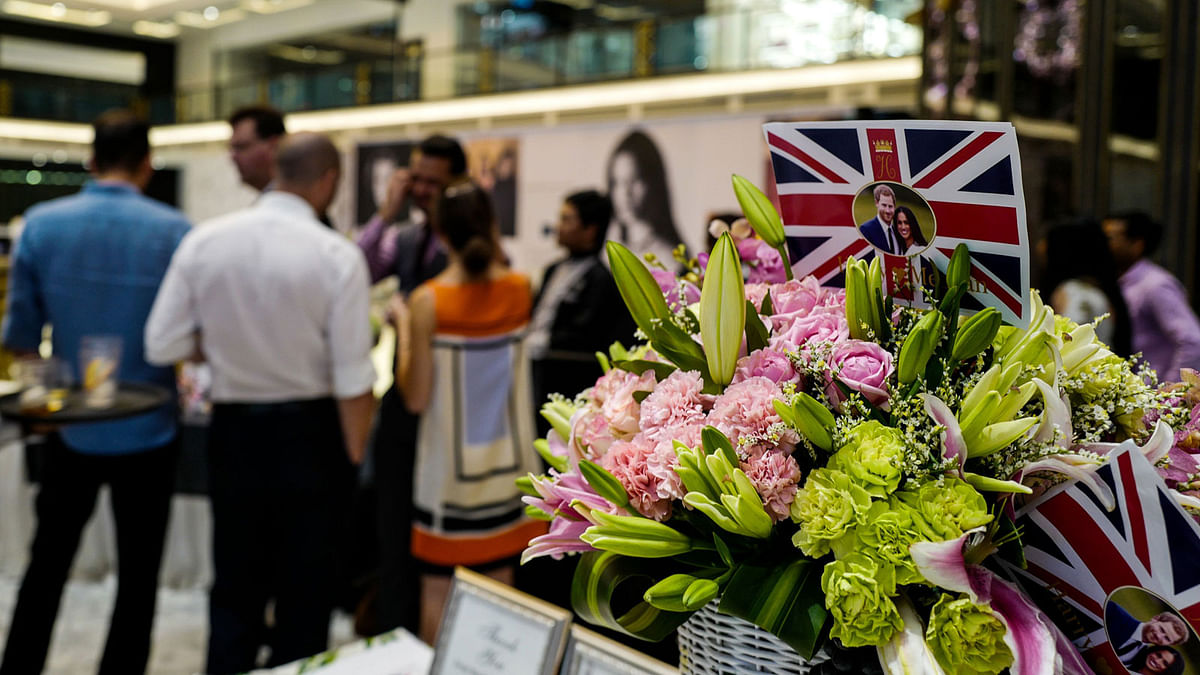 Flags bearing the image of Great Britain`s prince Harry and US actress Meghan Markle is displayed during a event to celebrate their wedding in Delhi on 18 May 2018. The couple will be married on 19 May at St George`s Chapel in Windsor Castle. Photo: AFP