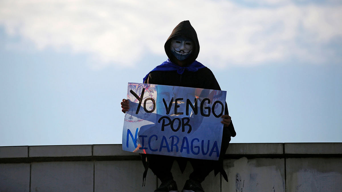 A masked protester holds a sign that reads `I came for Nicaragua` during demonstration against president Daniel Ortega`s government in Managua, Nicaragua on 18 May 2018. Photo: Reuters