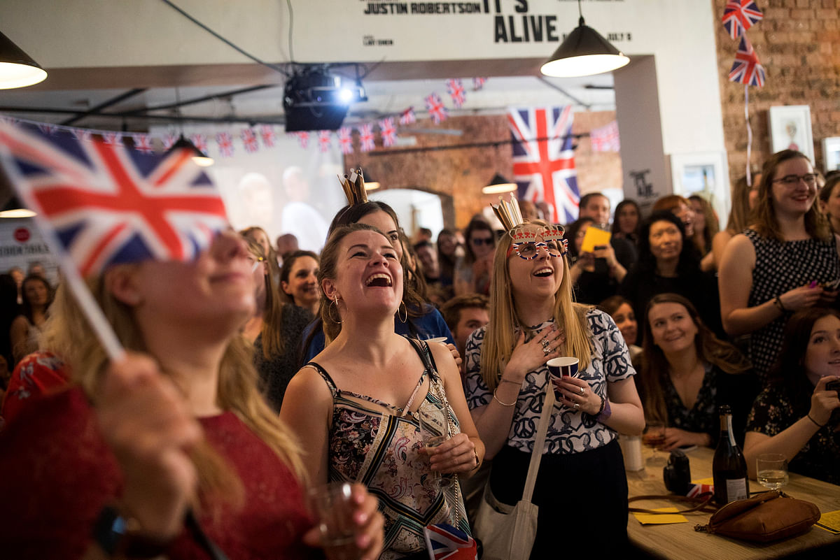 People react as they watch the wedding of Prince Harry and Meghan Markle at Windsor castle at the Book Club in London, Britain, 19 May, 2018. Photo: Reuters