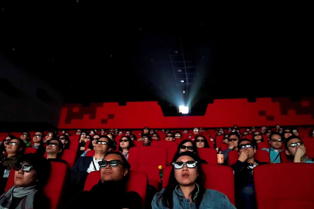 People watch a movie at a cinema in Wanda Group`s Oriental Movie Metropolis ahead of its opening, in Qingdao, Shandong province, China on 27 April. Reuters
