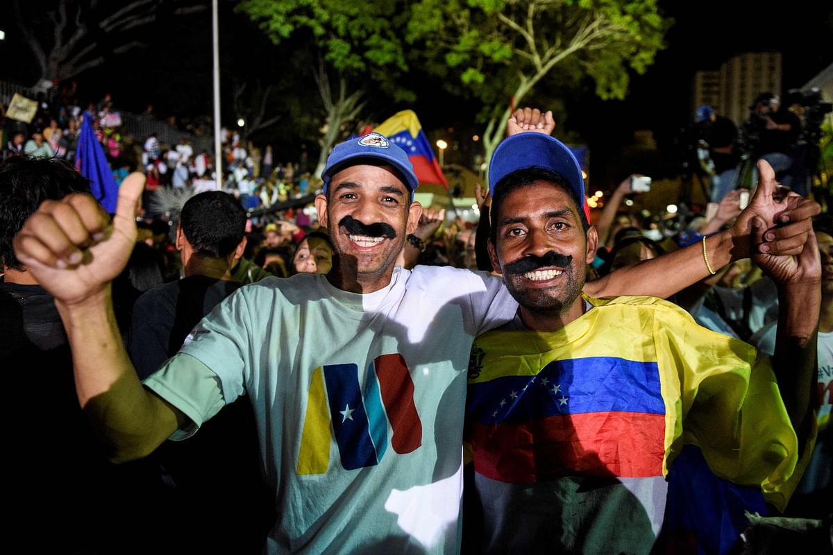 Supporters of the Venezuelan President Nicolas Maduro celebrate after the National Electoral Council (CNE) announced the results of the voting on presidential election, on 20 May in Caracas, Venezuela. Photo: AFP