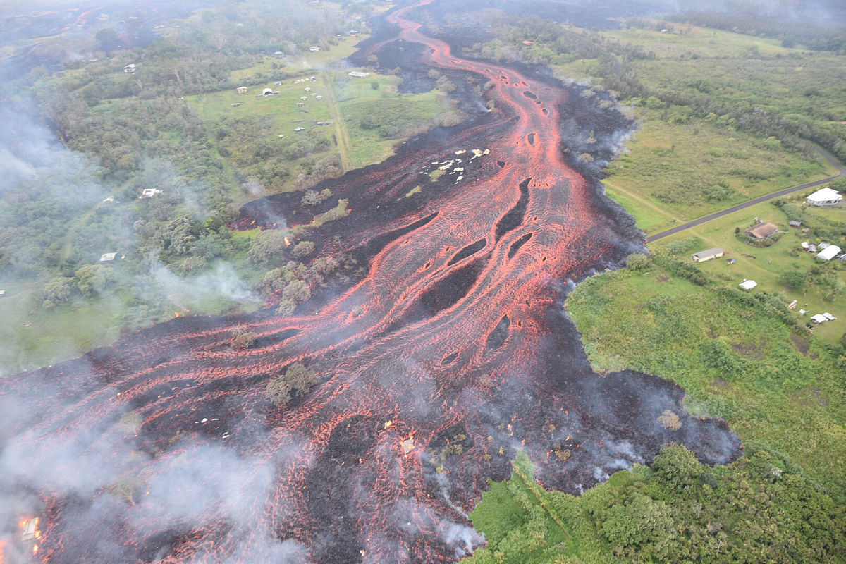Lava flows downhill, in this image from a helicopter overflight of Kilauea Volcano`s lower East Rift zone, during ongoing eruptions of the Kilauea Volcano in Hawaii, US, on 19 May 2018. Photo: Reuters