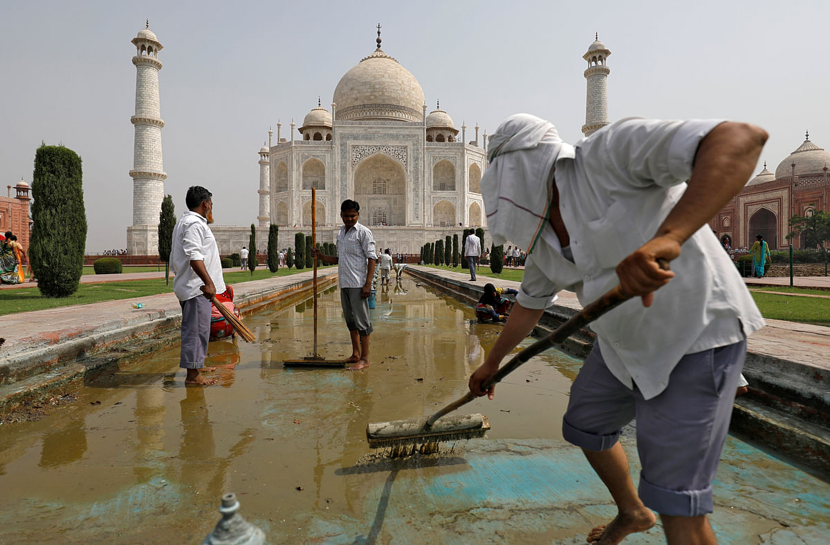 Labourers clean the fountain in the historic Taj Mahal premises in Agra, India, on 19 May 2018. Photo: Reuters