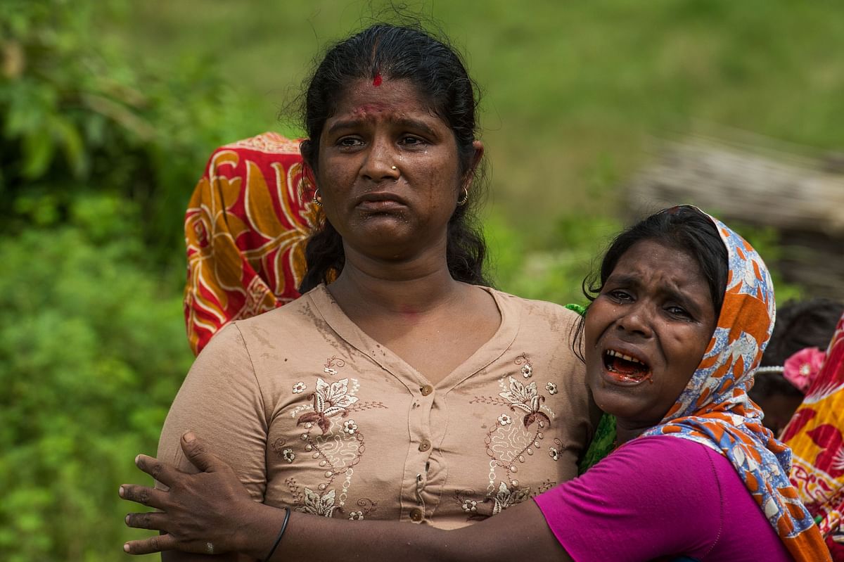 In this file photo taken on 27 September 2017, Hindu women cry near the dead bodies of their family members in Ye Baw Kyaw village, Maungdaw in Myanmar`s northern Rakhine state. Photo: AFP