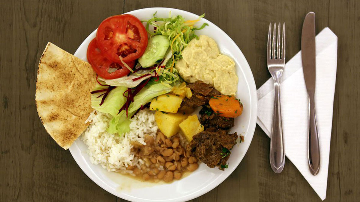 An iftar meal of bread, salad, humus, meat, potatoes, rice and beans is seen at a mosque in Sao Paulo, Brazil. Photo Reuters
