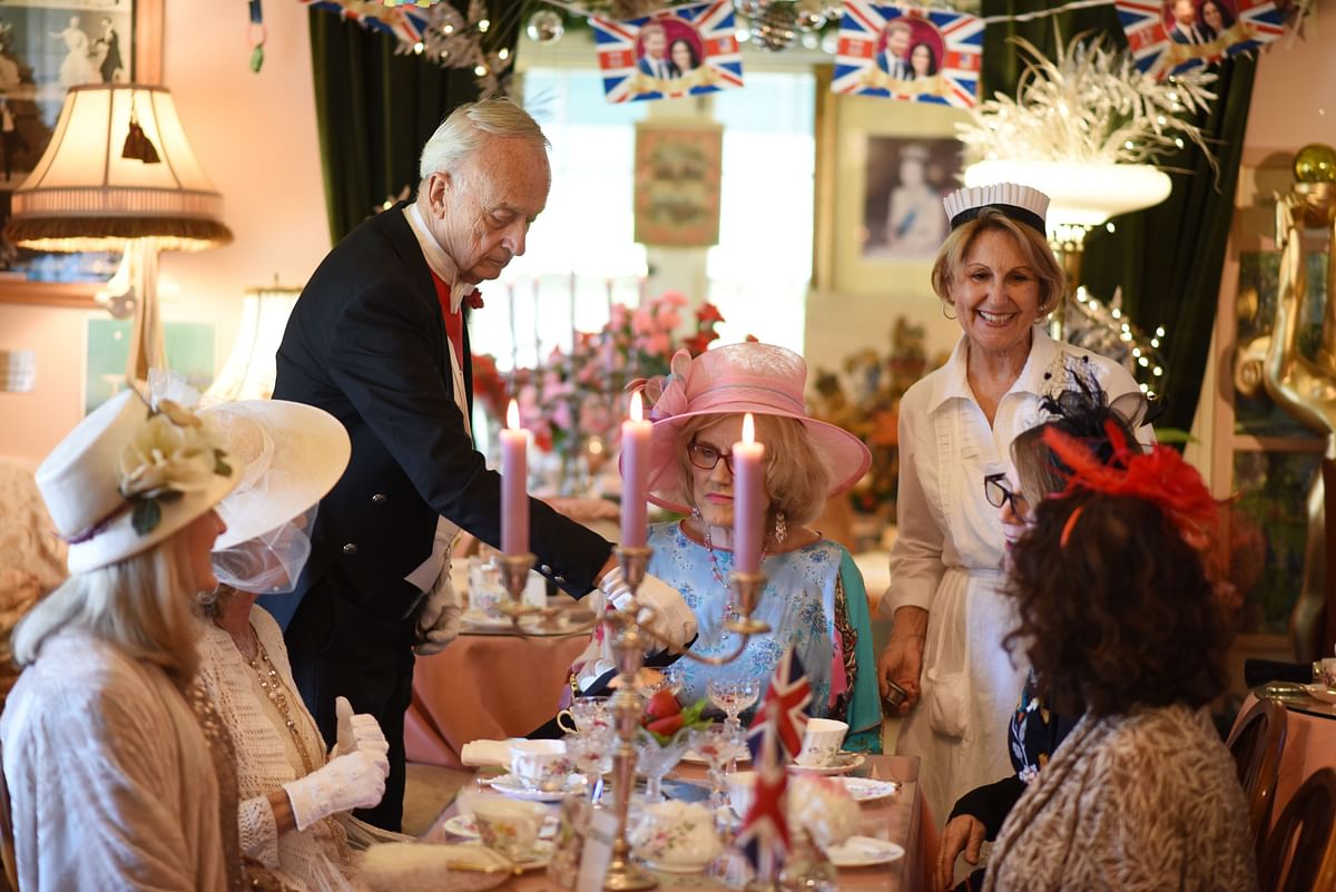 Owner Edmund Fry (L) attends to guests seated for traditional English afternoon tea at the Rose Tree Cottage in Pasadena, north of Los Angeles, California on 15 May 2018, where Meghan Markle has been a guest and owner Edumund Fry has offered her tips on how to correctly partake in afternoon tea.