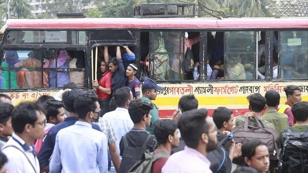 People face vehicle crisis everyday in Dhaka. In this photo taken by Shuvra Kanti Das from Karwanbazar of Dhaka on 23 May shows people waiting for bus.