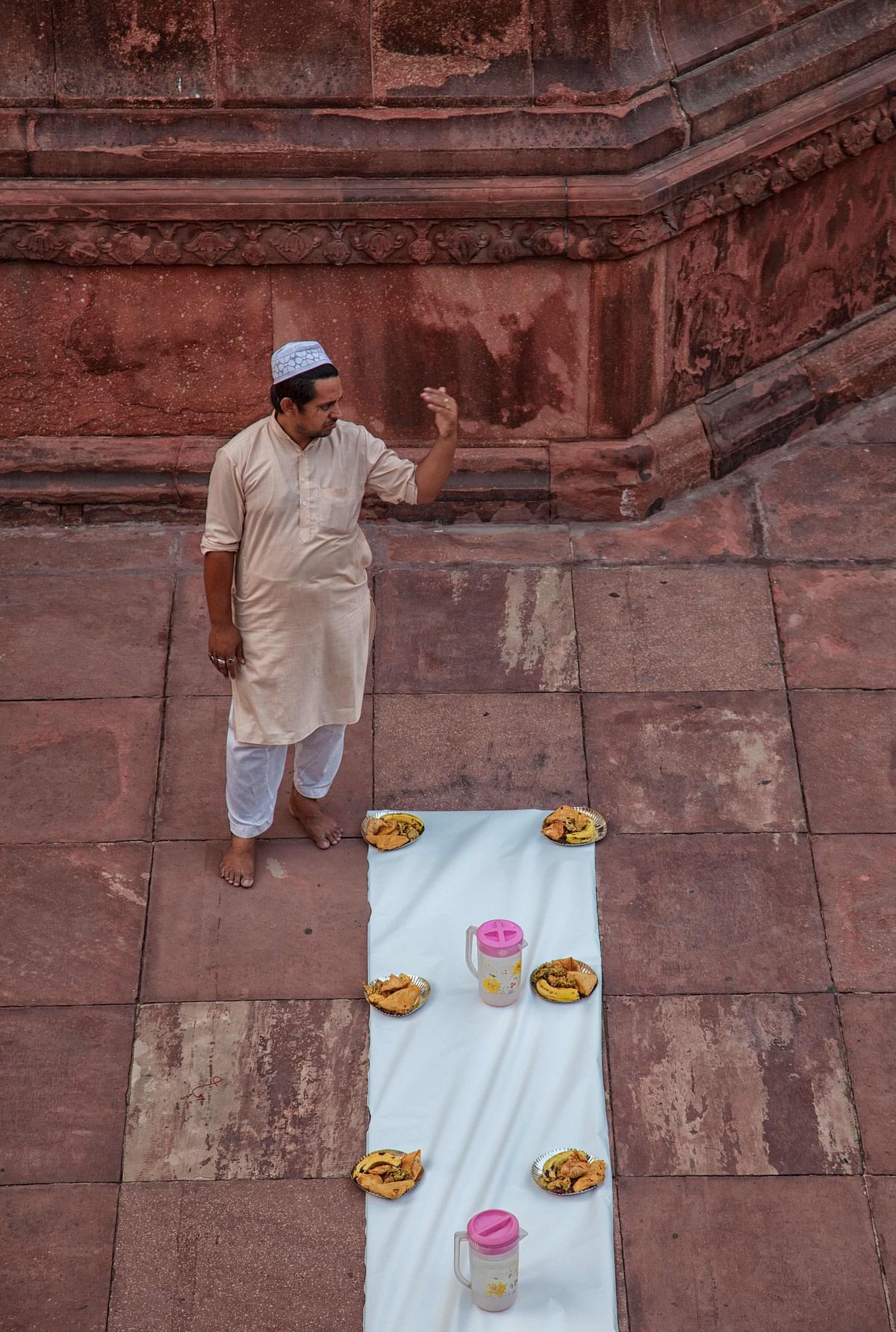 An Indian Muslim gestures ahead of Iftar, the breaking of the Ramadan fast on the first Friday of the Islamic holy month of Ramadan at Jama Masjid in New Delhi on 18 May 2018. Like millions of Muslim around the world, Indian Muslims mark the month of Ramadan by abstaining from eating, drinking, and smoking as well as sexual activities from dawn to dusk. Photo: AFP