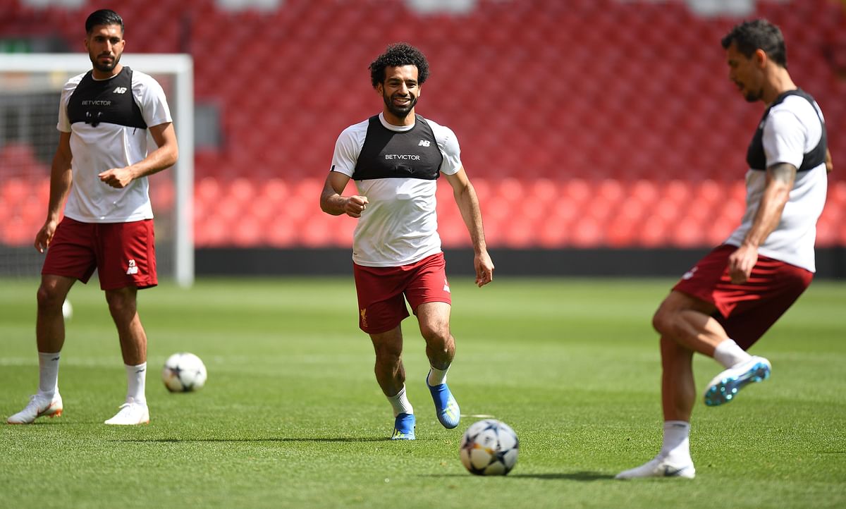 Liverpool`s German midfielder Emre Can (L), Liverpool`s Egyptian midfielder Mohamed Salah and Liverpool`s Croatian defender Dejan Lovren attends a training session and media day at Anfield stadium in Liverpool, north west England on May 21, 2018, ahead of their UEFA Champions League final football match against Real Madrid in Kiev on 26 May. AFP