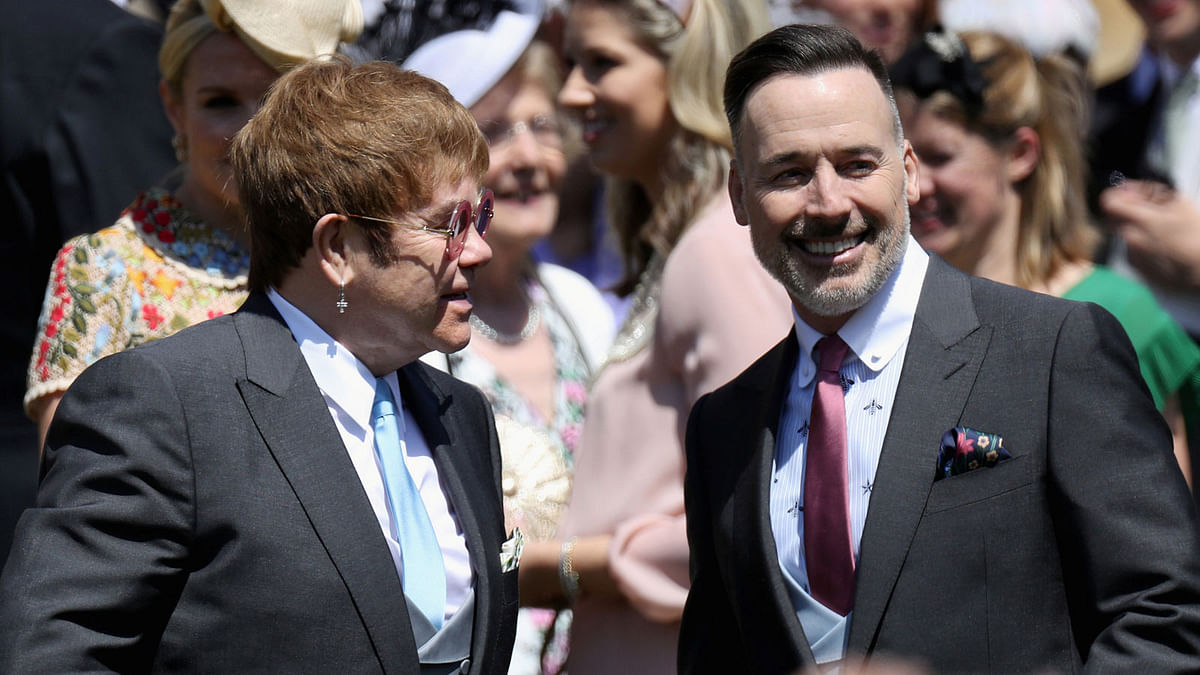 Elton John and David Furnish arrive at the wedding of Prince Harry to Ms Meghan Markle at St George`s Chapel, Windsor Castle in Windsor, Britain 19 May  2018. Photo: Reuters