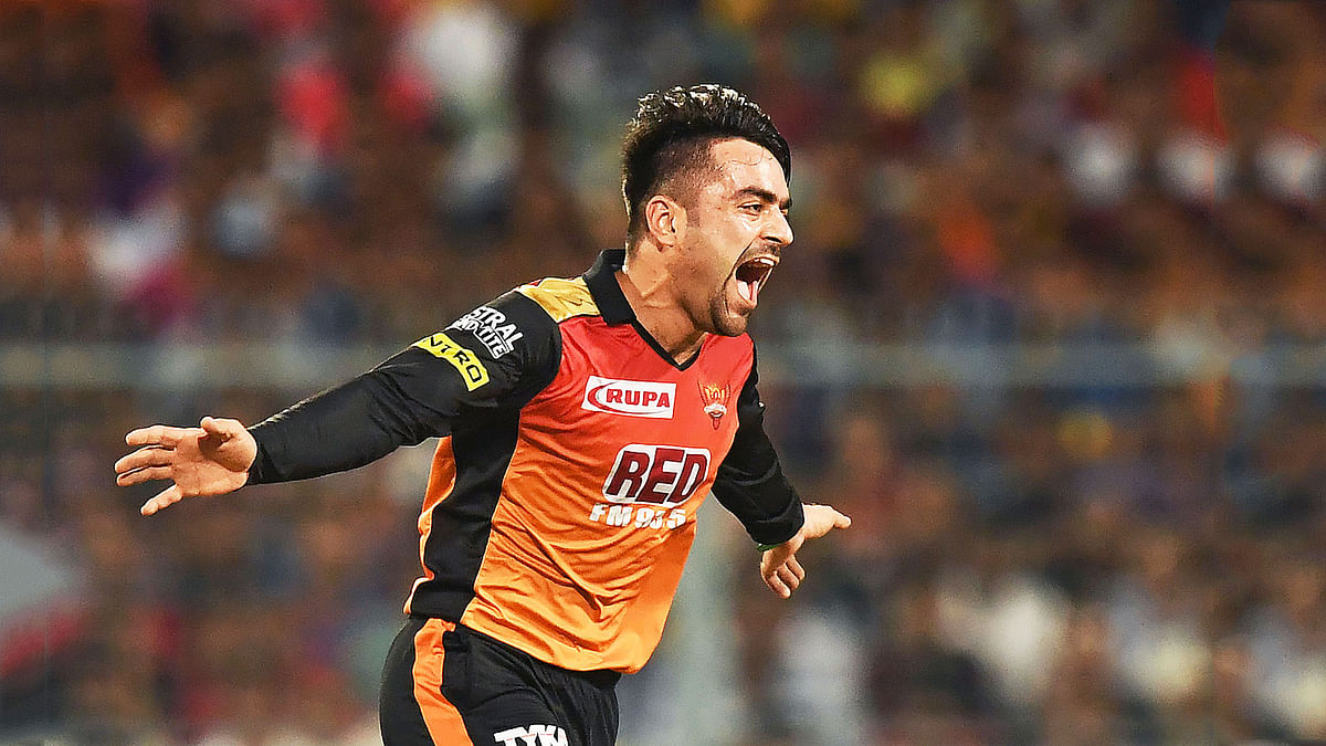 Sunrisers Hyderabad cricketer Rashid Khan celebrates after taking the wicket of Kolkata Knight Riders cricketer Andre Russell during the 2018 Indian Premier League (IPL) Twenty20 second Qualifier cricket match between Kolkata Knight Riders and Sunrisers Hyderabad at The Eden Gardens Cricket Stadium in Kolkata on 25 May 2018. Photo: AFP