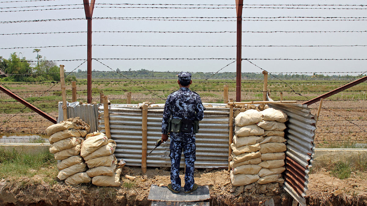 A Myanmar Border Guard Police officer keeps watch near the Taung Pyo Letwe reception camp overlooking the border with Bangladesh, in Rakhine state, Myanmar, on 1 May 2018. Photo: Reuters