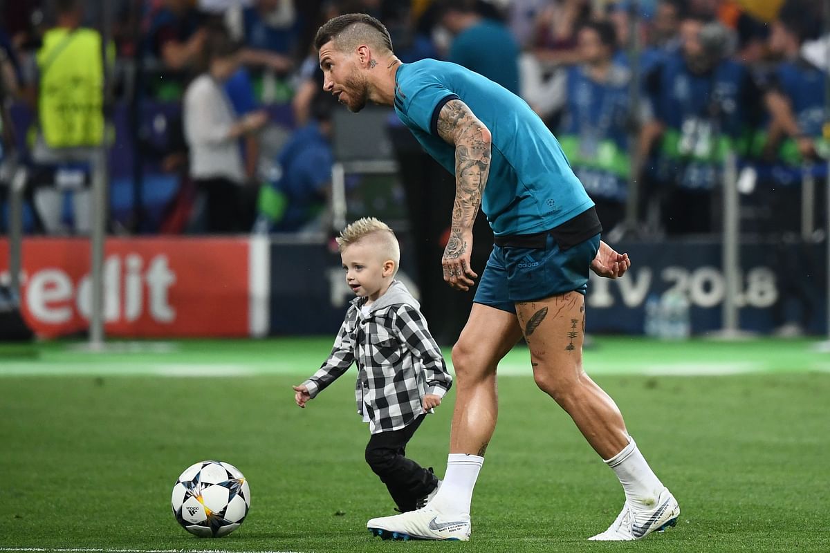 Real Madrid`s Spanish defender Sergio Ramos plays football with his son after a Real Madrid team training session at the Olympic Stadium in Kiev, Ukraine on 25 May 2018. Photo: AFP