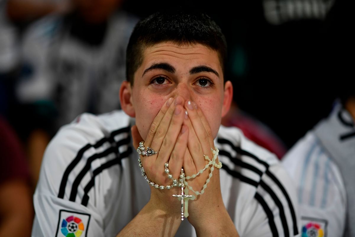 A Real Madrid fan reacts at the Santiago Bernabeu stadium after his team won the trophy. Photo: AFP
