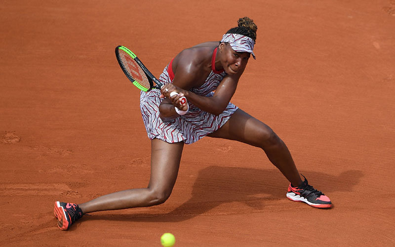 Venus Williams of the US plays a backhand return to China`s Wang Qiang during their women`s singles first round match on day one of The Roland Garros 2018 French Open tennis tournament in Paris on Sunday. AFP
