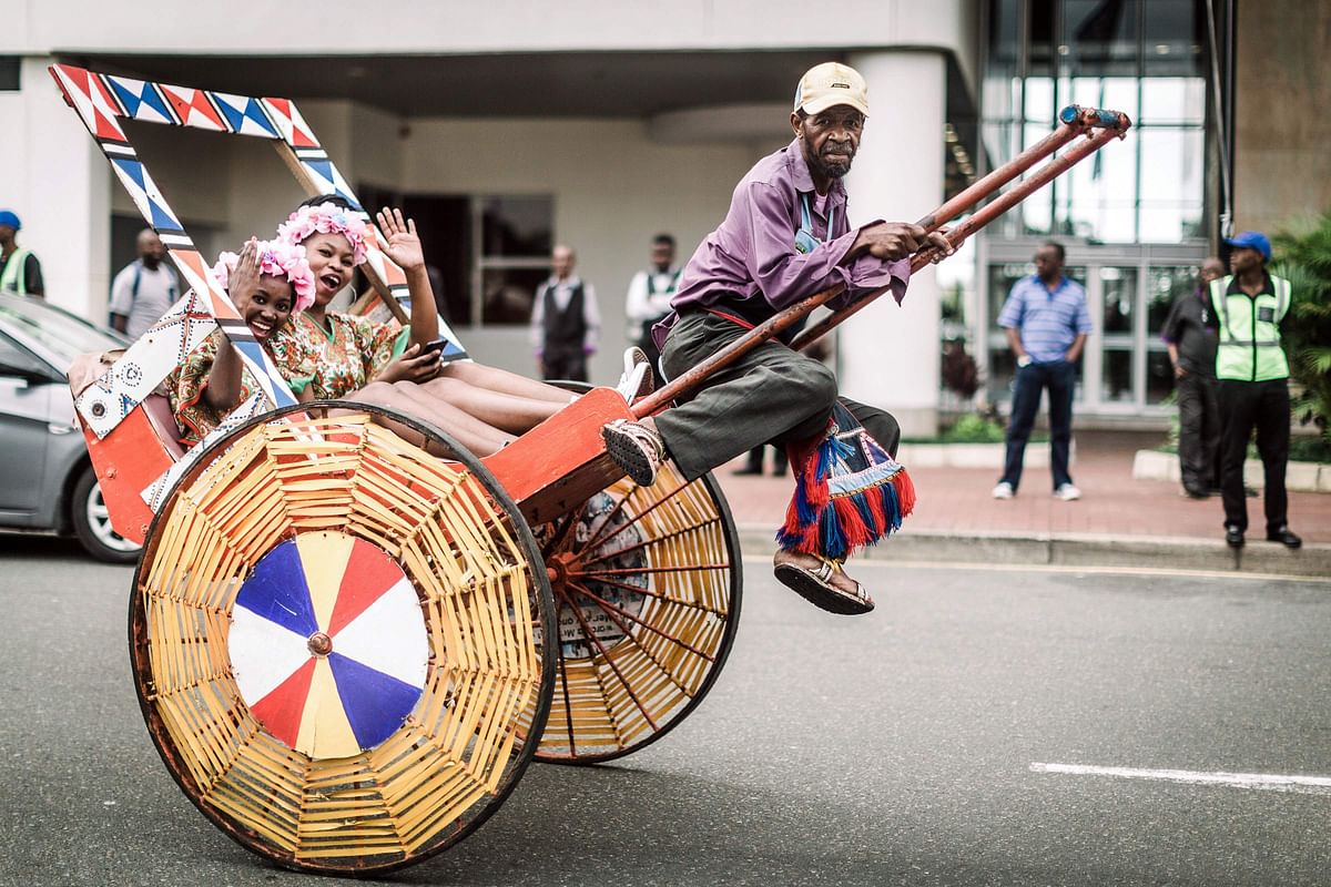 A rickshaw puller gestures as hundreds of people dressed in traditional attire in Durban take part on 26 May 2018 in a street carnival festival celebrating `Africa Month`. Photo: AFP