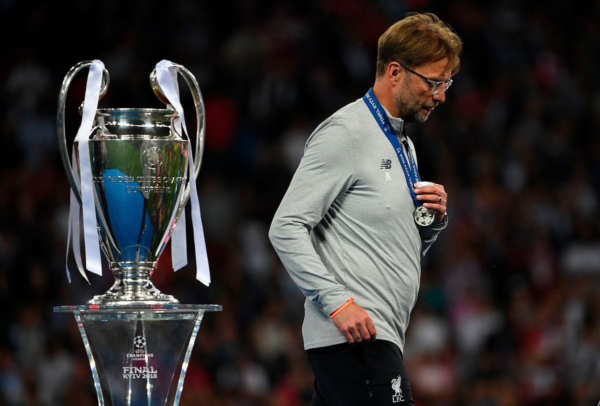 Liverpool`s German manager Jurgen Klopp walks past the trophy as he collects his loser`s medal. Photo: AFP