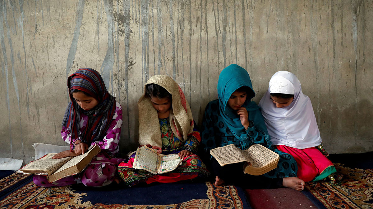 Afghan girls read the Koran in a madrasa, or religious school, during the Muslim holy month of Ramadan in Kabul, Afghanistan 28 May. Photo: Reuters